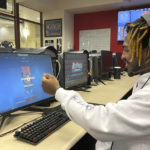 
              Shemar Worthy, a 21-year-old DePaul senior majoring in information systems, plays an online game at the university's Esports Gaming Center, Thursday, Sept. 22, 2022, in Chicago., where he says gaming was a gateway to his interest in a tech career. A growing effort to channel students' enthusiasm for esports toward preparing them for jobs in science, technology, engineering, and math could improve racial diversity in STEM. (AP Photo/Claire Savage)
            