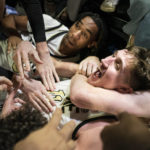 Wake Forest forward Andrew Carr, center, is hugged by teammates Lucas Taylor, left, and Cameron Hildreth (2) after Carr scored the game winning shot at the buzzer in the second half of an NCAA college basketball game against Appalachian State on Wednesday, Dec. 14, 2022, at Joel Coliseum in Winston-Salem, N.C. (Allison Lee Isley/The Winston-Salem Journal via AP)