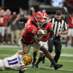 Georgia linebacker Smael Mondon Jr. (2) deflects the tackle against LSU wide receiver Brian Thomas Jr. (11) in the first half of the Southeastern Conference championship NCAA college football game, Saturday, Dec. 3, 2022, in Atlanta. (AP Photo/Brynn Anderson)
