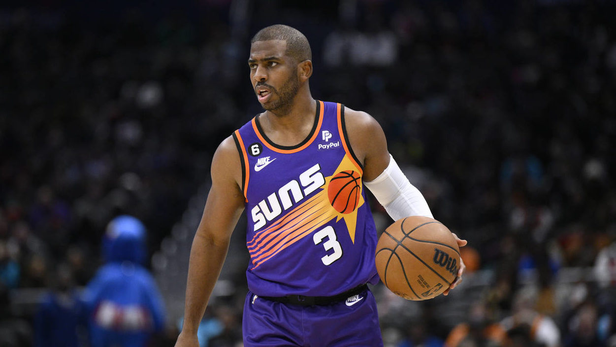 Phoenix Suns guard Chris Paul brings the ball up during the first half of the team's NBA basketball...