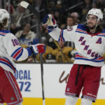 
              New York Rangers center Mika Zibanejad (93), right, celebrates after scoring against the Vegas Golden Knights for the second time during the third period of an NHL hockey game Wednesday, Dec. 7, 2022, in Las Vegas. (AP Photo/John Locher)
            