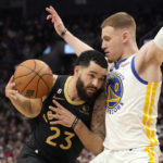 Toronto Raptors guard Fred VanVleet (23) tries to move past Golden State Warriors guard Donte DiVincenzo (0) during the first half of an NBA basketball game in Toronto, Sunday, Dec. 18, 2022. (Frank Gunn/The Canadian Press via AP)