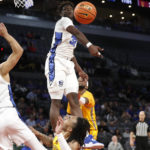 Creighton center Fredrick King rejects a shot by Arizona State guard Frankie Collins, below center, during the second half of an NCAA college basketball game, Monday, Dec. 12, 2022, in Las Vegas. Arizona State beat Creighton, 73-71. (AP Photo/Steve Marcus)