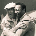 
              FILE - Brazilian soccer star Pele, and New York Cosmos coach Julio Mazzei, embrace at Giants Stadium in East Rutherford, N.J., April 16, 1982. Mazzei helped persuaded Pele to play in the United States and coached the Cosmos to a North American Soccer League title in 1982. Pelé, the Brazilian king of soccer who won a record three World Cups and became one of the most commanding sports figures of the last century, died in Sao Paulo on Thursday, Dec. 29, 2022. He was 82.  (AP Photo/Seth Rubenstein, File)
            