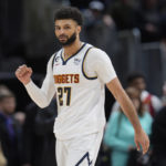 Denver Nuggets guard Jamal Murray gestures to the crowd after hitting a pair of free throws late in the second half of an NBA basketball game against the Utah Jazz, Saturday, Dec. 10, 2022, in Denver. (AP Photo/David Zalubowski)
