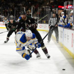 Buffalo Sabres' Jeremy Davis (4) is tripped by Arizona Coyotes' Lawson Crouse (67) as they battle for the puck in the first period during an NHL hockey game, Saturday, Dec. 17, 2022, in Tempe, Ariz. (AP Photo/Darryl Webb)