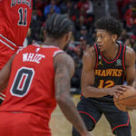 Atlanta Hawks forward De'Andre Hunter guards the ball against Chicago Bulls forward DeMar DeRozan (11) and guard Coby White (0), left, during the second half of an NBA basketball game on Wednesday, Dec. 21, 2022, in Atlanta. (AP Photo/Erik Rank)