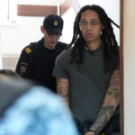 FILE - WNBA star and two-time Olympic gold medalist Brittney Griner is escorted to a courtroom for a hearing, in Khimki just outside Moscow, Russia, Monday, June 27, 2022. Her case not only brought unprecedented public attention to the dozens of Americans wrongfully detained by foreign governments, but it also emerged as a major inflection point in U.S.-Russia diplomacy at a time of deteriorating relations prompted by Moscow's war against Ukraine. (AP Photo/Alexander Zemlianichenko, File)