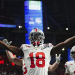 Ohio State wide receiver Marvin Harrison Jr. (18) celebrates hos touchdown catch against Georgia during the first half of the Peach Bowl NCAA college football semifinal playoff game, Saturday, Dec. 31, 2022, in Atlanta. (AP Photo/John Bazemore)