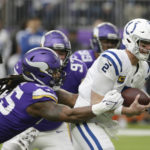 Indianapolis Colts quarterback Matt Ryan (2) is tackled by Minnesota Vikings linebacker Za'Darius Smith (55) during the first half of an NFL football game, Saturday, Dec. 17, 2022, in Minneapolis. (AP Photo/Andy Clayton-King)
