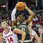 Lehigh's Bube Momah (23) grabs an offensive rebound over Wisconsin's Carter Gilmore (14) and Tyler Wahl, right, during the first half of an NCAA college basketball game Thursday, Dec. 15, 2022, in Madison, Wis. (AP Photo/Andy Manis)