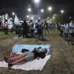 
              Fans waits for the arrival of the Argentine soccer team that won the World Cup outside the AFA training grounds in Buenos Aires, Argentina, Tuesday, Dec. 20, 2022. (AP Photo/Matilde Campodonico)
            