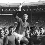 
              FILE - England's soccer team captain Bobby Moore, is carried shoulder high by his teammates holding World Cup at the Wembley Stadium in London, July 30, 1966. From left to right, goalkeeper Gordon Banks, Alan Ball, Roger Hunt, Geoff Hurst, Moore, Ray Wilson, George Cohen and Bobby Charlton. George Cohen, the right-back for England World Cup-winning team of 1966, has died aged 83, his former club Fulham have announced on Friday, Dec. 23, 2022. (AP Photo/Bippa, File)
            