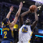 
              Golden State Warriors forward Draymond Green (23) shoots over Indiana Pacers guard Andrew Nembhard (2) during the first half of an NBA basketball game in Indianapolis, Wednesday, Dec. 14, 2022. (AP Photo/Michael Conroy)
            