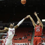 Utah guard Rollie Worster (25) shoots while defended by Washington State guard Kymany Houinsou (31) during the second half of an NCAA college basketball game, Sunday, Dec. 4, 2022, in Pullman, Wash. Utah won 67-65. (AP Photo/Young Kwak)