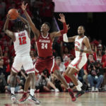 
              Houston guard Tramon Mark (12) is defended by Alabama forward Brandon Miller (24) during the first half of an NCAA college basketball game, Saturday, Dec. 10, 2022, in Houston. (AP Photo/Kevin M. Cox)
            