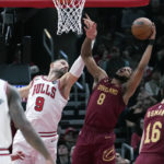 
              Cleveland Cavaliers forward Lamar Stevens (8) rebounds the ball against Chicago Bulls center Nikola Vucevic during the first half of an NBA basketball game in Chicago, Saturday, Dec. 31, 2022. (AP Photo/Nam Y. Huh)
            