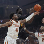 Arkansas-Pine Bluff forward Ismael Plet (45) drives to the basket between Texas forward Dylan Disu (4) and guard Marcus Carr (2) during the first half of an NCAA college basketball game in Austin, Texas, Saturday, Dec. 10, 2022. (AP Photo/Eric Gay)