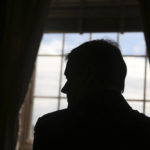 
              Massachusetts Governor Charlie Baker is seen in silhouette during an interview at the Massachusetts State House Tuesday Dec. 27, 2022, in Boston, Mass. (AP Photo/Reba Saldanha)
            
