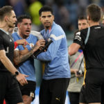 
              Uruguay's Jose Gimenez argues with the referee at the end of a World Cup group H soccer match against Ghana at the Al Janoub Stadium in Al Wakrah, Qatar, Friday, Dec. 2, 2022. (AP Photo/Darko Vojinovic)
            