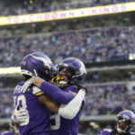 
              Minnesota Vikings wide receiver Justin Jefferson, left, celebrates with wide receiver Adam Thielen, right, after catching a 10-yard touchdown pass during the second half of an NFL football game against the New York Jets, Sunday, Dec. 4, 2022, in Minneapolis. (AP Photo/Andy Clayton-King)
            
