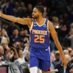 Phoenix Suns' Mikel Bridges signals three after making a 3-pointer against the Washington Wizards during the first half of an NBA basketball game in Phoenix, Tuesday, Dec. 20, 2022. (AP Photo/Darryl Webb)