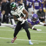 New York Jets wide receiver Corey Davis (84) catches a pass ahead of Minnesota Vikings cornerback Duke Shelley (20) during the second half of an NFL football game, Sunday, Dec. 4, 2022, in Minneapolis. (AP Photo/Andy Clayton-King)