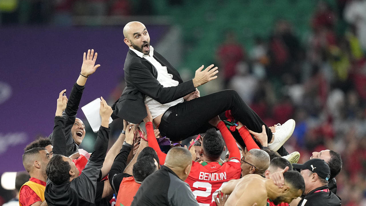 Morocco's head coach Walid Regragui is thrown in the air by players after the World Cup quarterfina...