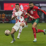 
              Croatia's Ivan Perisic, left, and /mo19, fight for the ball during the World Cup third-place playoff soccer match between Croatia and Morocco at Khalifa International Stadium in Doha, Qatar, Friday, Dec. 16, 2022. (AP Photo/Thanassis Stavrakis)
            