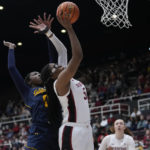 Stanford forward Francesca Belibi (5) shoots while defended by California forward Ugonne Onyiah during the first half of an NCAA college basketball game in Stanford, Calif., Friday, Dec. 23, 2022. (AP Photo/Godofredo A. Vásquez)