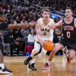 
              Purdue guard Braden Smith (3) drives between Davidson guard Desmond Watson (4) and guard Foster Loyer (0) in the first half of an NCAA college basketball game in Indianapolis, Saturday, Dec. 17, 2022. (AP Photo/Michael Conroy)
            