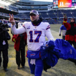 Buffalo Bills quarterback Josh Allen (17) waves to fans as he leaves the field following an NFL football game against the Chicago Bears in Chicago, Saturday, Dec. 24, 2022. The Bills defeated the Bears 35-13.(AP Photo/Charles Rex Arbogast)