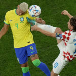 
              Croatia's Luka Modric, right, fights for the ball with Brazil's Richarlison during the World Cup quarterfinal soccer match between Croatia and Brazil, at the Education City Stadium in Al Rayyan, Qatar, Friday, Dec. 9, 2022. (AP Photo/Alessandra Tarantino)
            