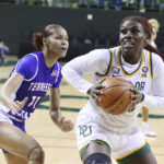 Baylor guard Aijha Blackwell (33) drives on Tennessee State forward Kennedy Davis (11) in the first half of an NCAA college basketball game, Thursday, Dec. 15, 2022, in Waco, Texas. (Rod Aydelotte/Waco Tribune-Herald, via AP)