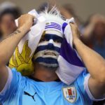 
              An Uruguay soccer fan reacts as he watches the team's World Cup soccer match against Portugal on a large screen in Montevideo, Uruguay, Monday, Nov. 28, 2022. Uruguay lost the match 0-2. (AP Photo/Matilde Campodonico)
            
