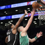 Boston Celtics guard Payton Pritchard drives against Brooklyn Nets forward Royce O'Neale (00) during the first half of an NBA basketball game, Sunday, Dec. 4, 2022, in New York. (AP Photo/Jessie Alcheh)