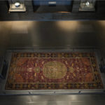 
              Visitors look at an Iranian carpet at the Museum of Islamic Art in Doha, Qatar, Tuesday, Nov. 22, 2022. (AP Photo/Christophe Ena)
            