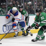 Dallas Stars' Tyler Seguin (91) and Ty Dellandrea attempt to take control of the puck against Edmonton Oilers' Evan Bouchard in the first period of an NHL hockey game, Wednesday, Dec. 21, 2022, in Dallas. (AP Photo/Tony Gutierrez)