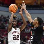 
              Louisville forward Kamari Lands (22) shoots over Miami guard Isaiah Wong (2) during the second half of an NCAA college basketball game in Louisville, Ky., Sunday, Dec. 4, 2022. Miami won 80-53. (AP Photo/Timothy D. Easley)
            