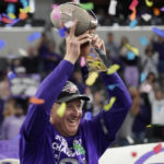Kansas State head coach Chris Klieman holds the trophy after Kansas State defeated TCU in the Big 12 Conference championship NCAA college football game, Saturday, Dec. 3, 2022, in Arlington, Texas. (AP Photo/LM Otero)