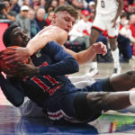 Arizona's Pelle Larsson, right, wraps up Morgan State's Malik Miller, left, as they battle for loose ball during the first half of an NCAA college basketball game, Thursday, Dec. 22, 2022, in Tucson, Ariz. (AP Photo/Darryl Webb)