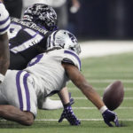 
              TCU's Gunnar Henderson, center, and Kansas State's Phillip Brooks, right, reach for a fumble on a punt in the second of the Big 12 Conference championship NCAA college football game, Saturday, Dec. 3, 2022, in Arlington, Texas. TCU recovered the fumble. (AP Photo/LM Otero)
            