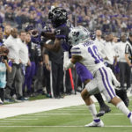 TCU running back Trent Battle (17) catches a pass for a first down while defended by Kansas State cornerback Jacob Parrish (10) in the second half of the Big 12 Conference championship NCAA college football game, Saturday, Dec. 3, 2022, in Arlington, Texas. (AP Photo/LM Otero)
