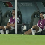 Portugal's Cristiano Ronaldo, right, sits on the bench during the World Cup group H soccer match between South Korea and Portugal, at the Education City Stadium in Al Rayyan , Qatar, Friday, Dec. 2, 2022. (AP Photo/Hassan Ammar)
