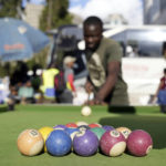 
              People play pool in an open space in Harare, Zimbabwe, Wednesday, Nov. 30, 2022. Previously a minority and elite sport in Zimbabwe, the game has increased in popularity over the years, first as a pastime and now as a survival mode for many in a country where employment is hard to come by. (AP Photo/Tsvangirayi Mukwazhi)
            