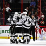 
              Los Angeles Kings players surround left wing Kevin Fiala after his goal on Ottawa Senators goaltender Cam Talbot during the second period of an NHL hockey game, Tuesday, Dec. 6, 2022, in Ottawa, Ontario. (Justin Tang/The Canadian Press via AP)
            