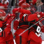 Detroit Red Wings left wing Elmer Soderblom, center, celebrates with defenseman Moritz Seider (53) and center Joe Veleno, right, after scoring against the Ottawa Senators during the third period of an NHL hockey game Saturday, Dec. 31, 2022, in Detroit. (AP Photo/Duane Burleson)