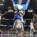 New York Knicks forward Julius Randle (30) is fouled by Indiana Pacers center Myles Turner (33) during the second half of an NBA basketball game in Indianapolis, Sunday, Dec. 18, 2022. (AP Photo/AJ Mast)