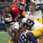 Georgia running back Kenny McIntosh (6) fights his way into the end zone against LSU linebacker West Weeks (33) for a touchdown in the second half of the Southeastern Conference Championship football game Saturday, Dec. 3, 2022 in Atlanta. (AP Photo/John Bazemore)