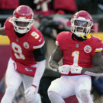 Kansas City Chiefs running back Jerick McKinnon (1) celebrates after scoring as teammates JuJu Smith-Schuster (9) watches during the first half of an NFL football game against the Seattle Seahawks Saturday, Dec. 24, 2022, in Kansas City, Mo. (AP Photo/Charlie Riedel)